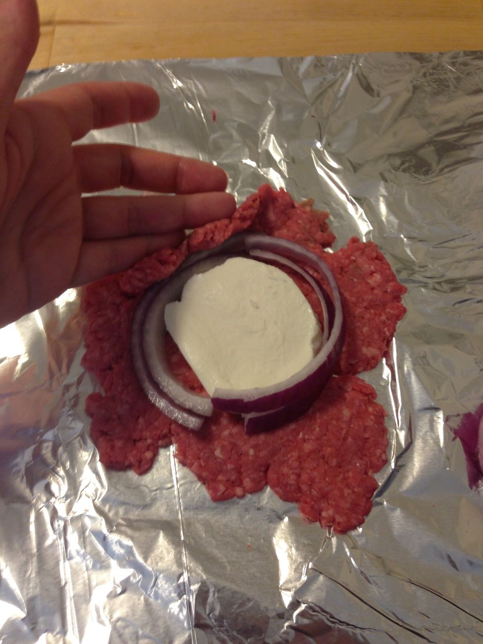 Now fold the beef over the mozzarella and onion. If you can't completely cover it, add more beef to the top.