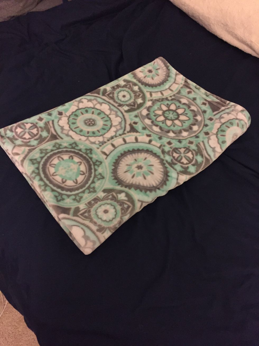 Now fold the blanket where the crease is in the middle where the two halves meet.