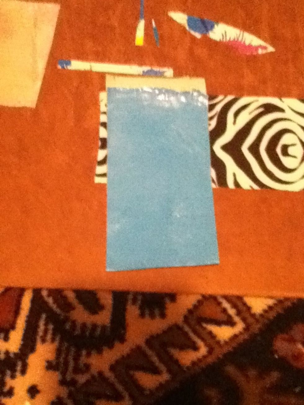 Now fold the "body" piece almost in half, but leaving a little bit of the sticky side left