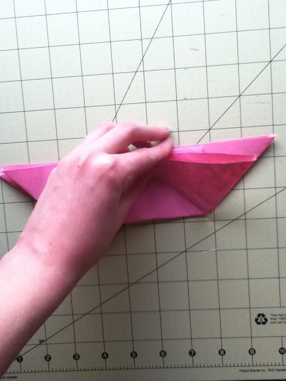 Now, fold the flap so that it touches the middle.