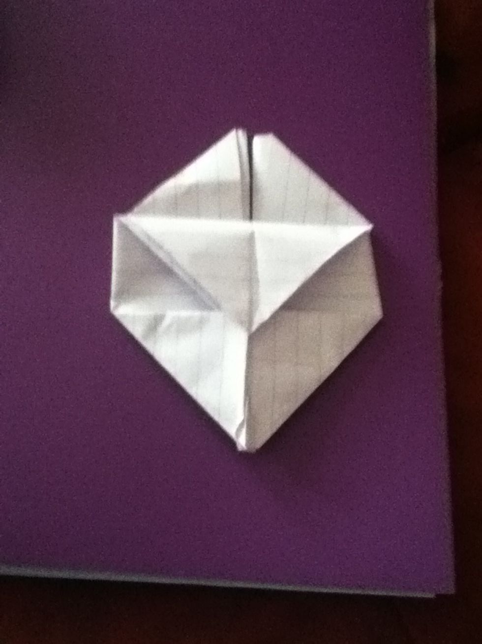 Now fold the full triangle back and tuck the two corner pieces in to the flap.