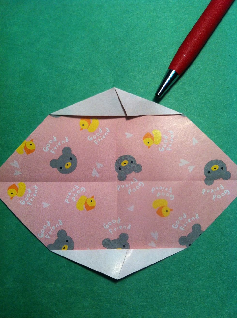 Now fold the other side along that crease, too...for the top & bottom. Ok. Fold in half...left side to the right side.