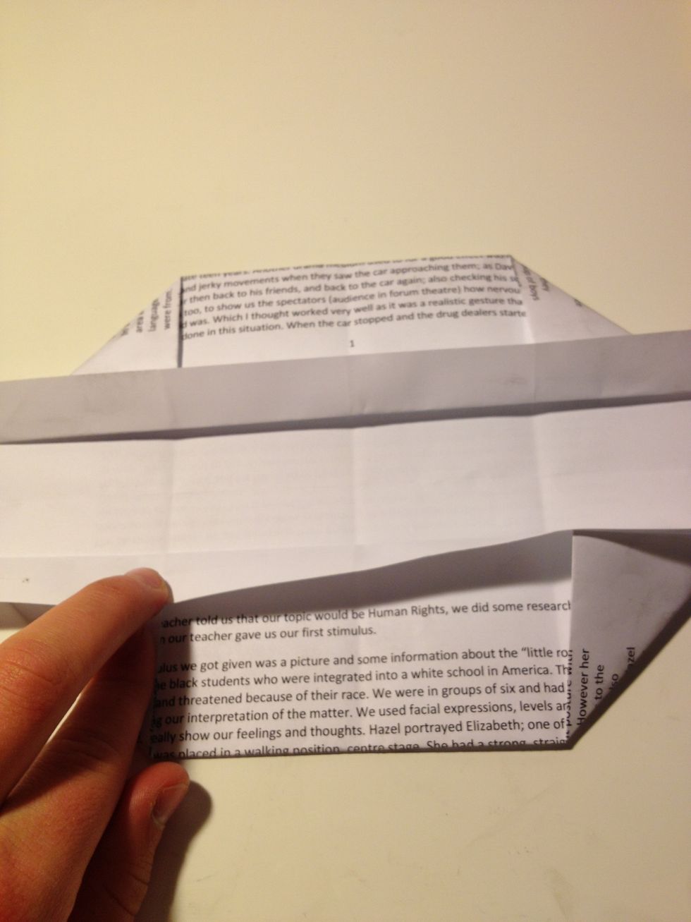 Now fold the strip of paper thats above each corner fold downwards so it covers the top of each corner fold