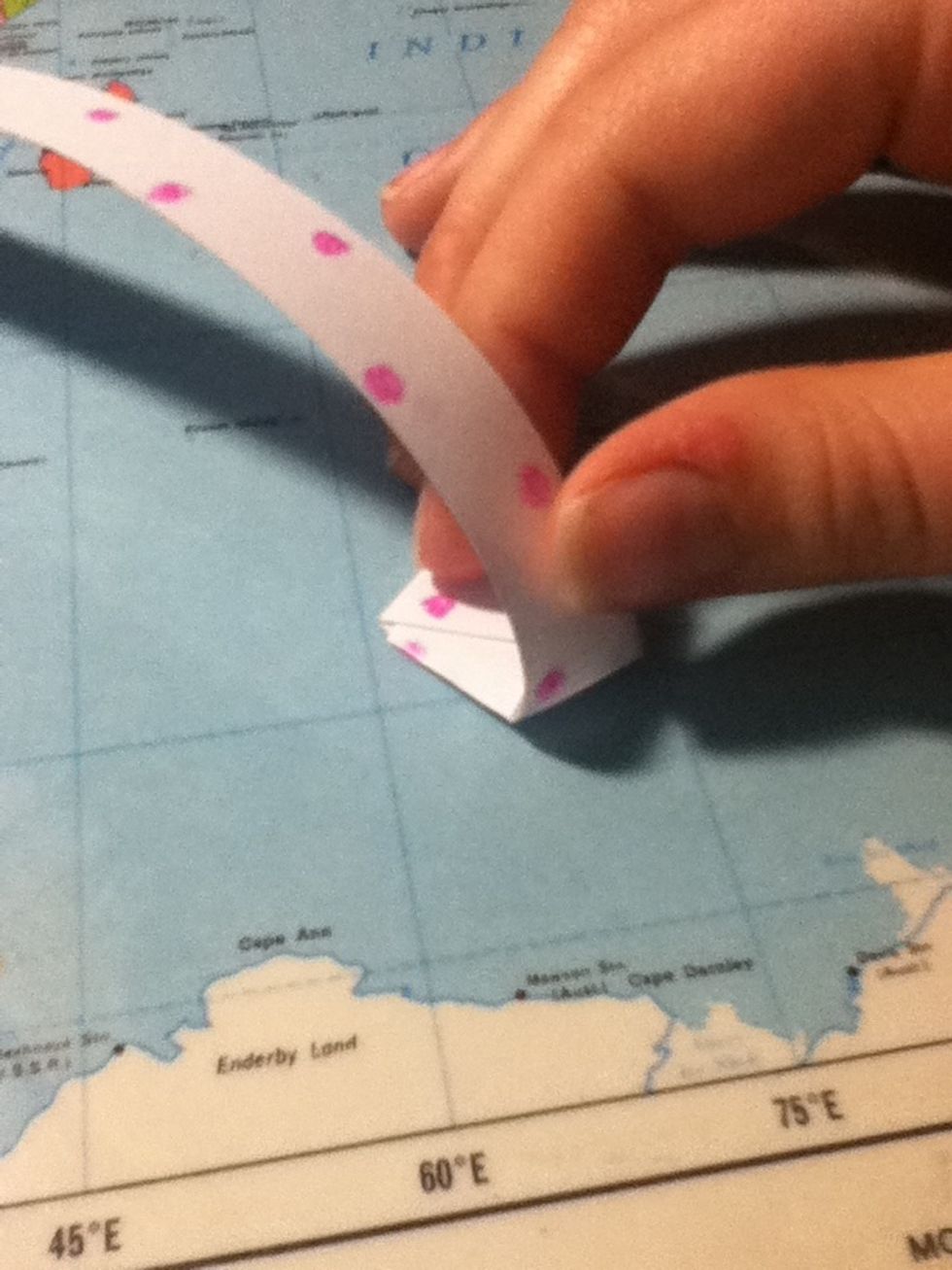 Now fold the strip over the hexagon