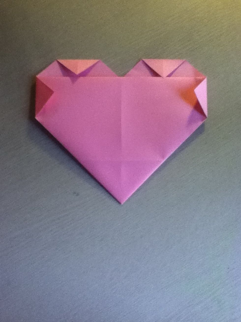 Now fold the top corners down