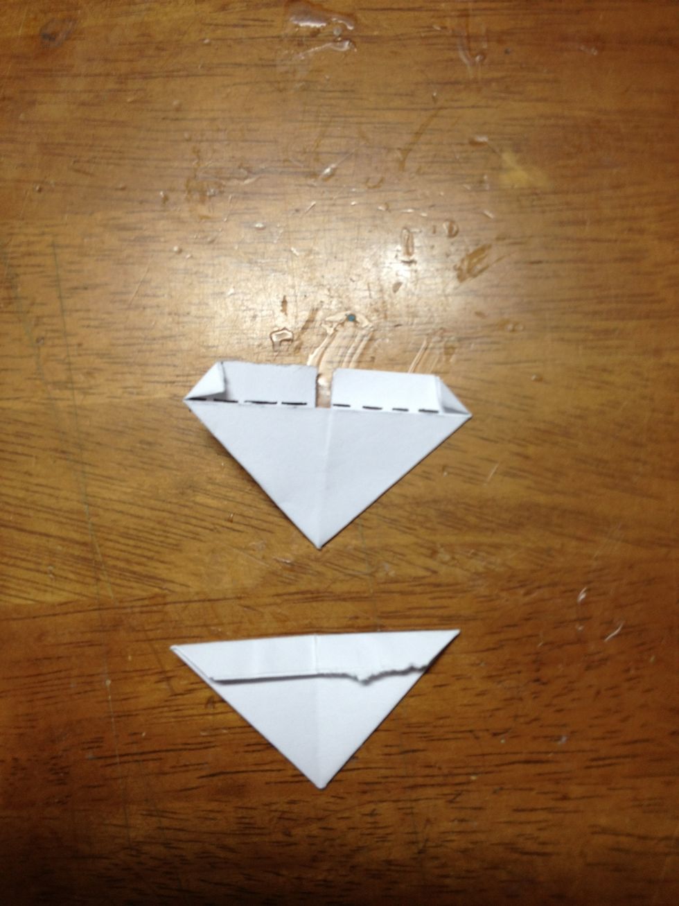 Now, fold the top flap of each side so that it lies flat on top of the lower half of the piece.