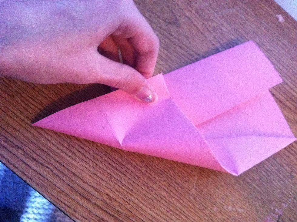 Now fold the two NOT FOLDED CORNERS like this.