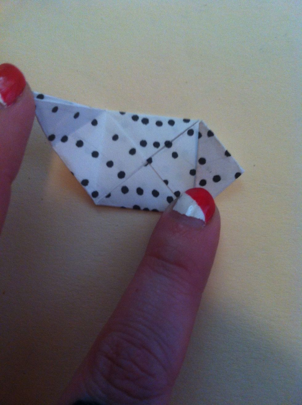 Now fold top left tip to bottom point.