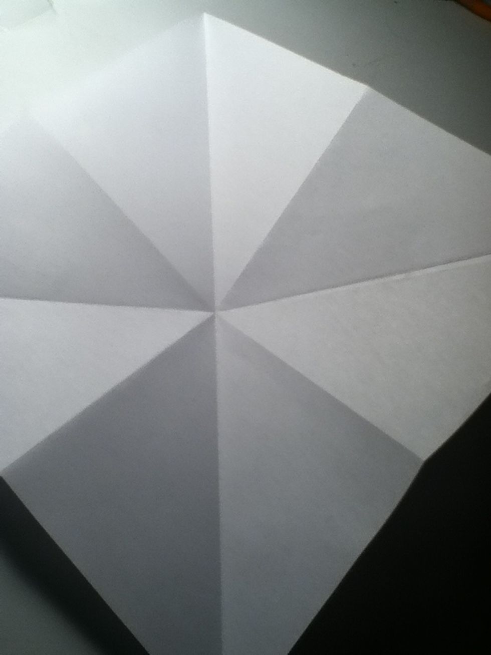 Now fold top point to the bottom point