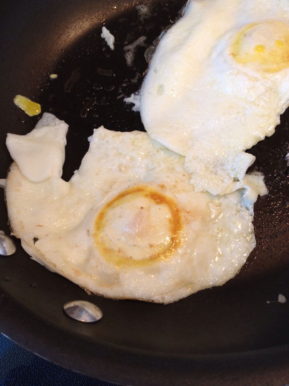 Now for secret # 2: remove the pan from heat. The residual heat of the pan is all you need to cook the top side of the egg.