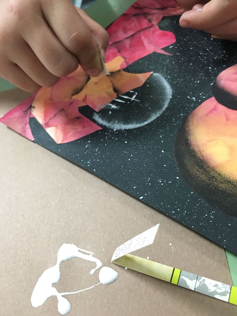 Now for the city. Using some cut strips of thick paper and white acrylic paint, paint some vertical lines to represent towers.