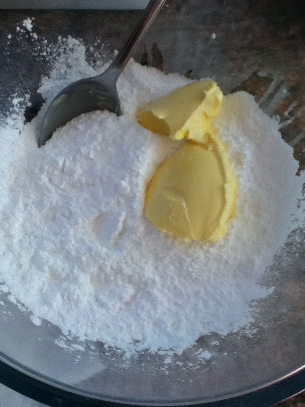 Now for the icing! Add about 2 tablespoons of butter and some icing sugar to the bowl.
