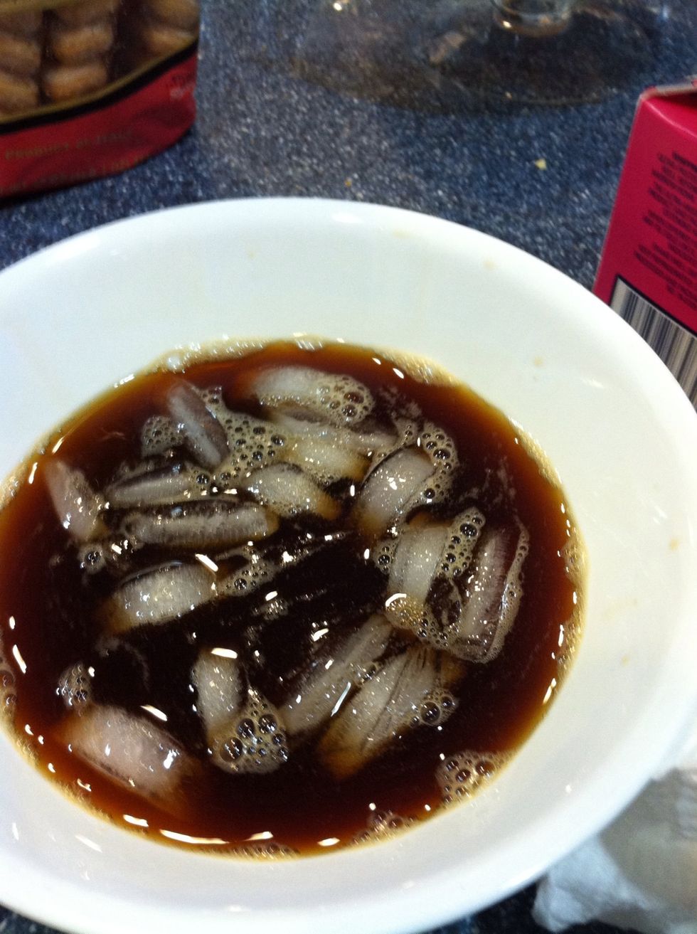 Now for the lady fingers... Quickly dip the lady fingers a couple at a time in iced coffee.