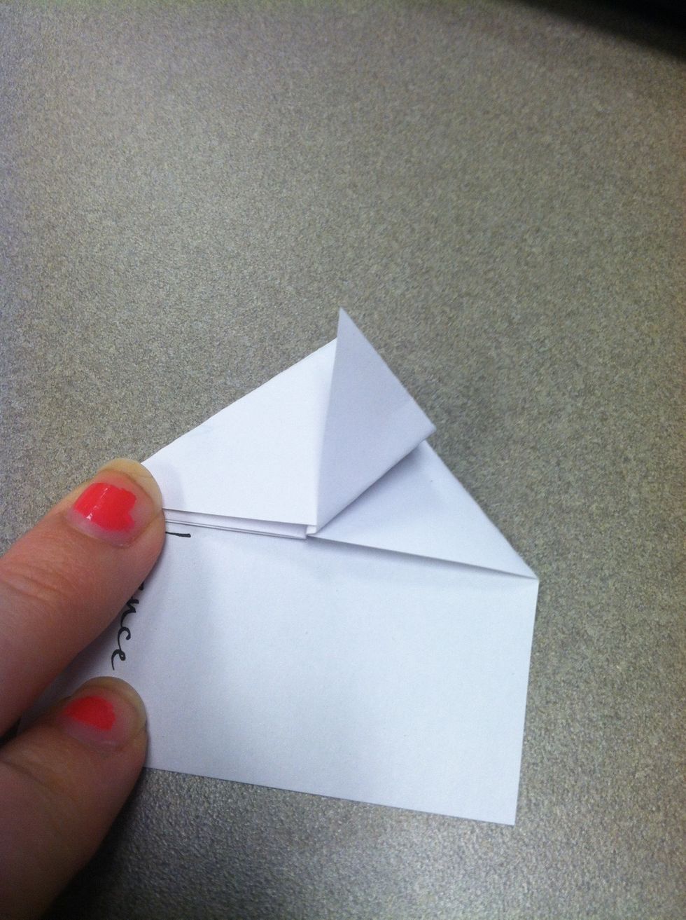 Now for the legs. Fold one of the corners up to the tip. Crease. Then do the same on the other side.