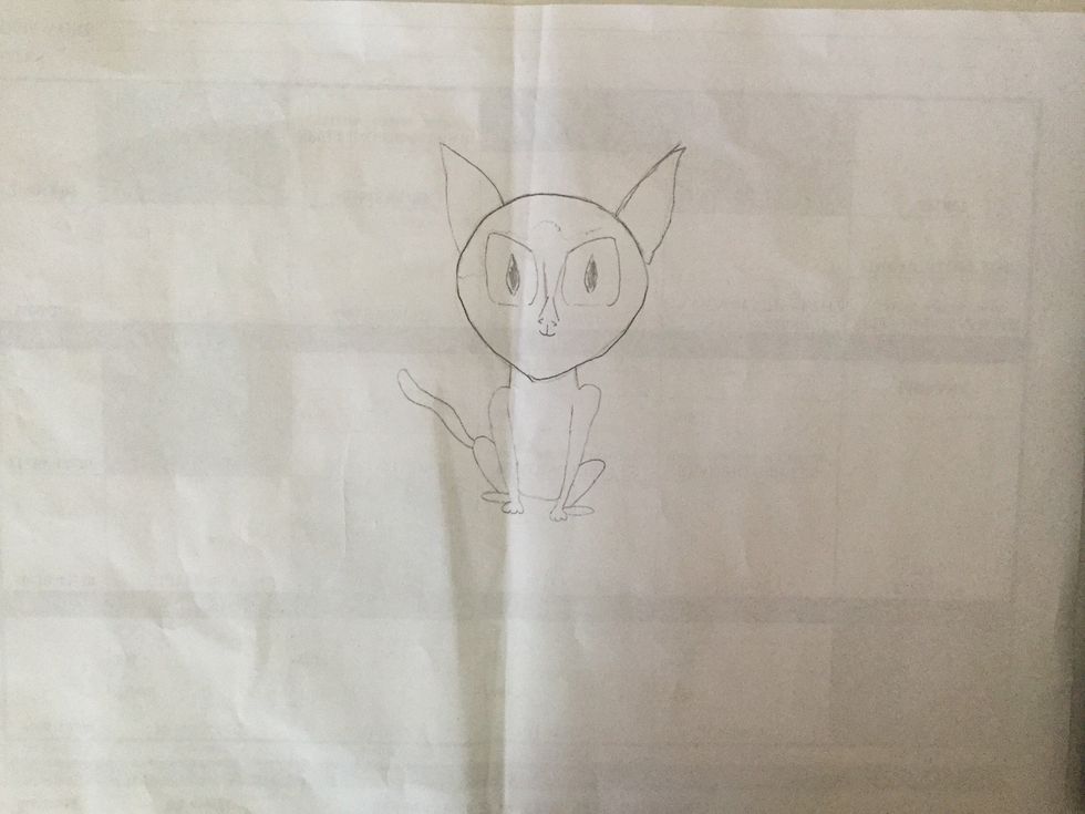 Now for the nose. Three centimetres down the middle of the face, lightly draw a small triangle. Below it draw two tiny lines curving slightly down next to each other.