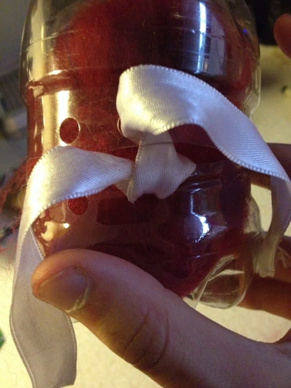 Now for the ribbon. Place it through the top right hole then through the bottom right hole..