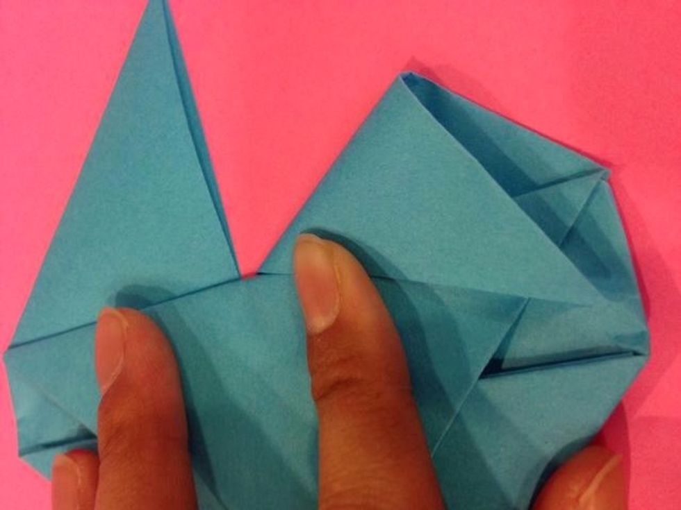 Now for the top were now creating the top of the heart - take the right top (tip) and fold it so that just like the bottom slipping into the pocket make it at an angle u wish and slip the top tip in