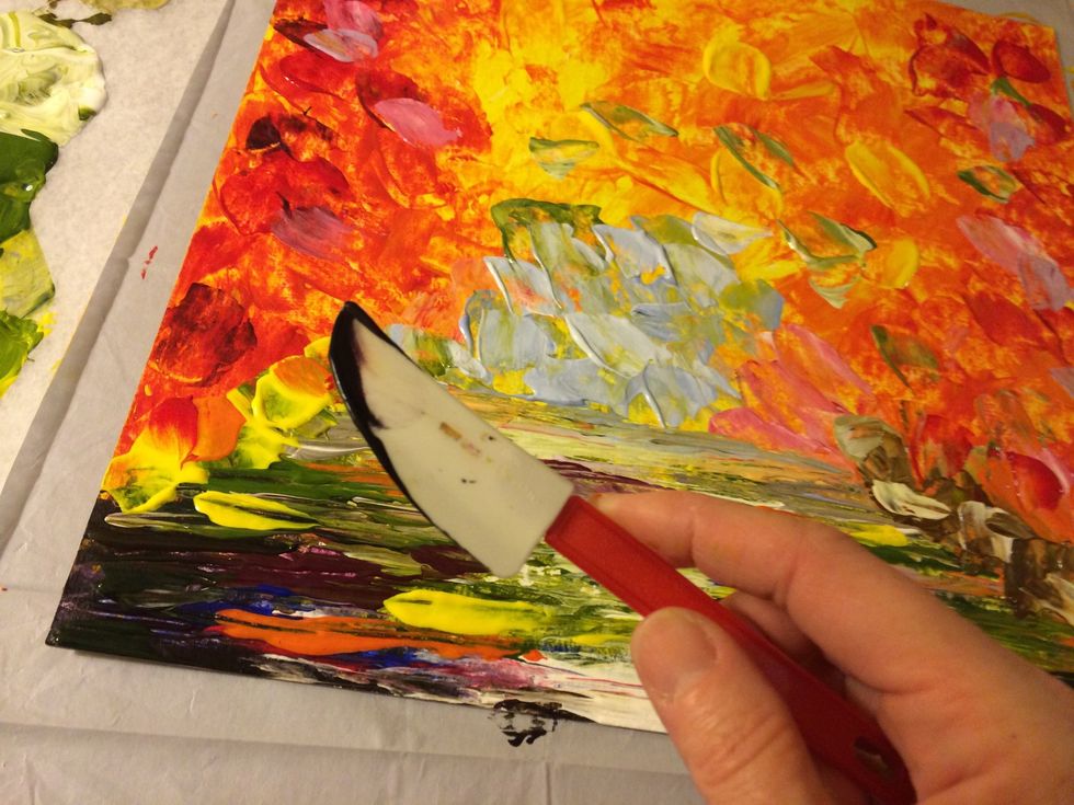 Now for the trees! Use a little dark blue and purple on the side of your knife and drag the knife down from the top of the canvas.