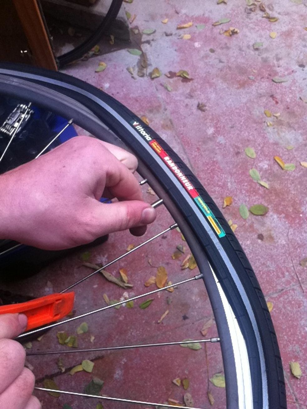 now for the very last part... push the valve up so the tube stays in the tire before snapping the final bit of bead in to the rim