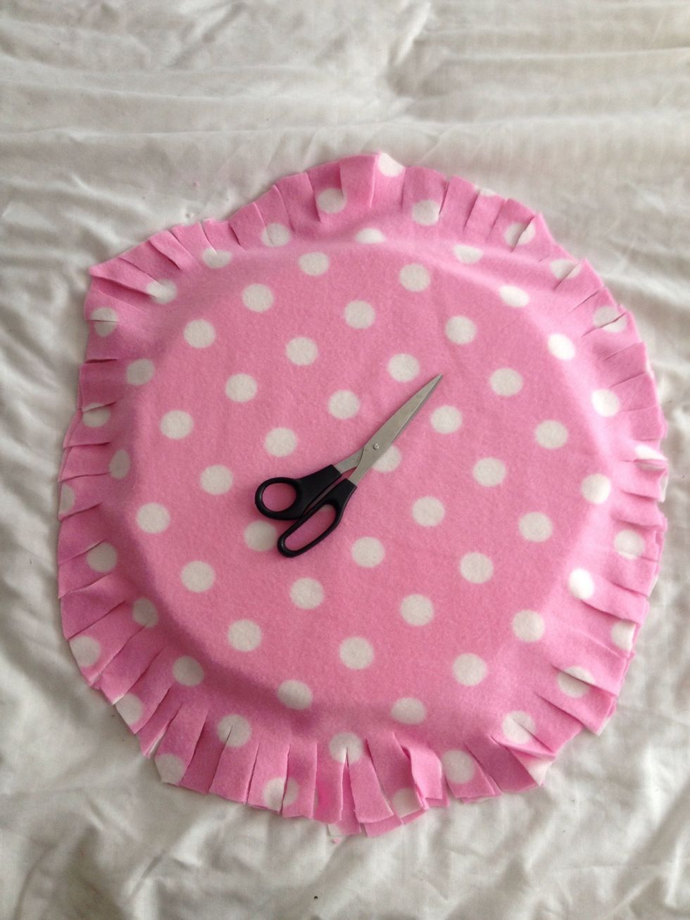 Now for your bed! Make at least 3 inch cuts all along fabric. I had foam in between the two fabric pieces but stuffing would work too! Just add it in later when your ties are almost done!