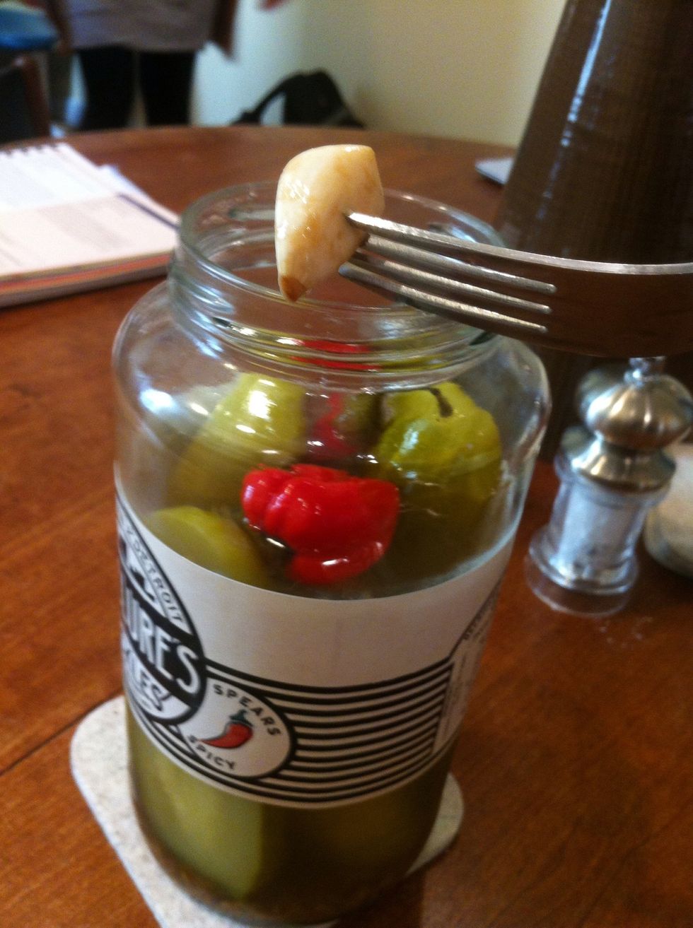 now for your garlic. I like to pull a clove or two out of the pickle brine. if you want the hummus to be extra spicy, drop a pepper in from the jar as well.