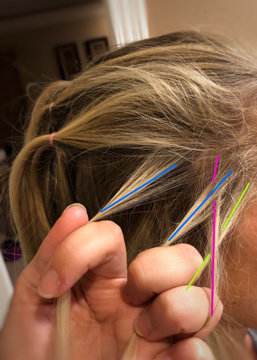 Now gather a small section of hair and add it to the blue (left) strand.