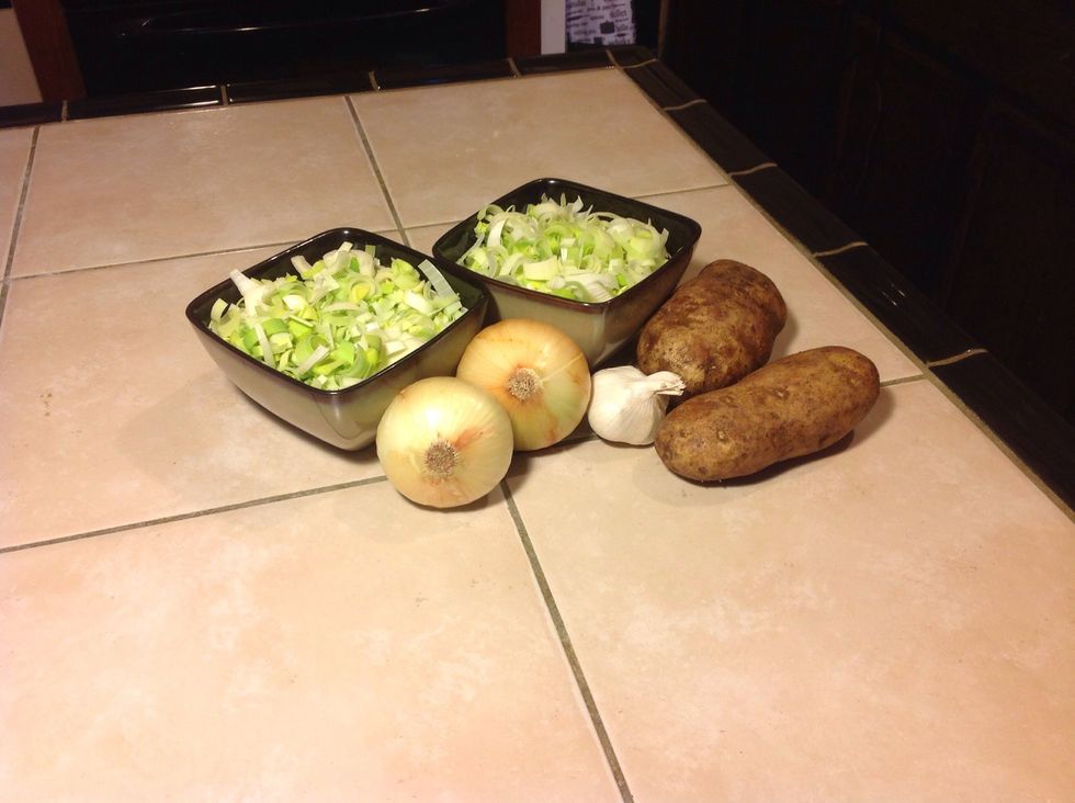 Now gather your ingredients. Roughly chop the onions, slice the garlic, half the leeks length way and slice, peal the potatoes and quarter length way then chop.
