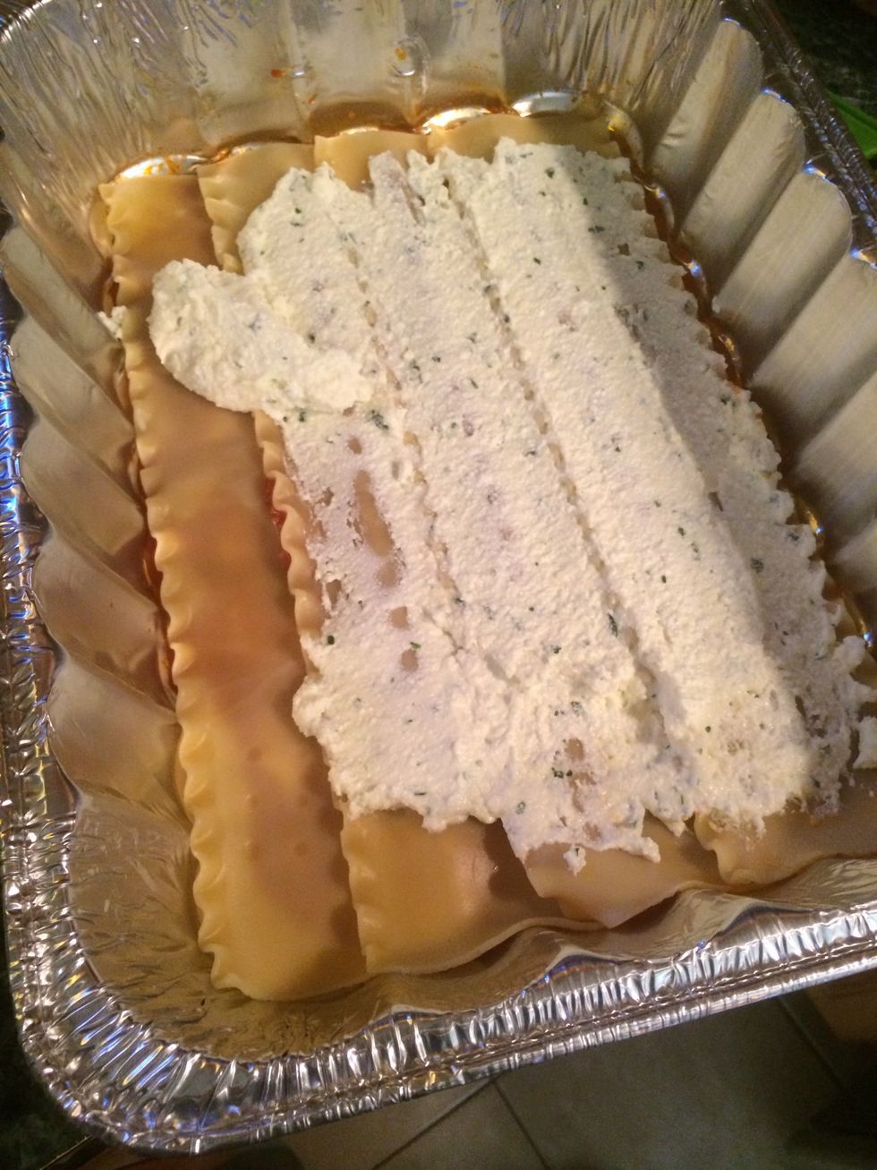 Now generously spread some of the ricotta onto the first layer of noodles