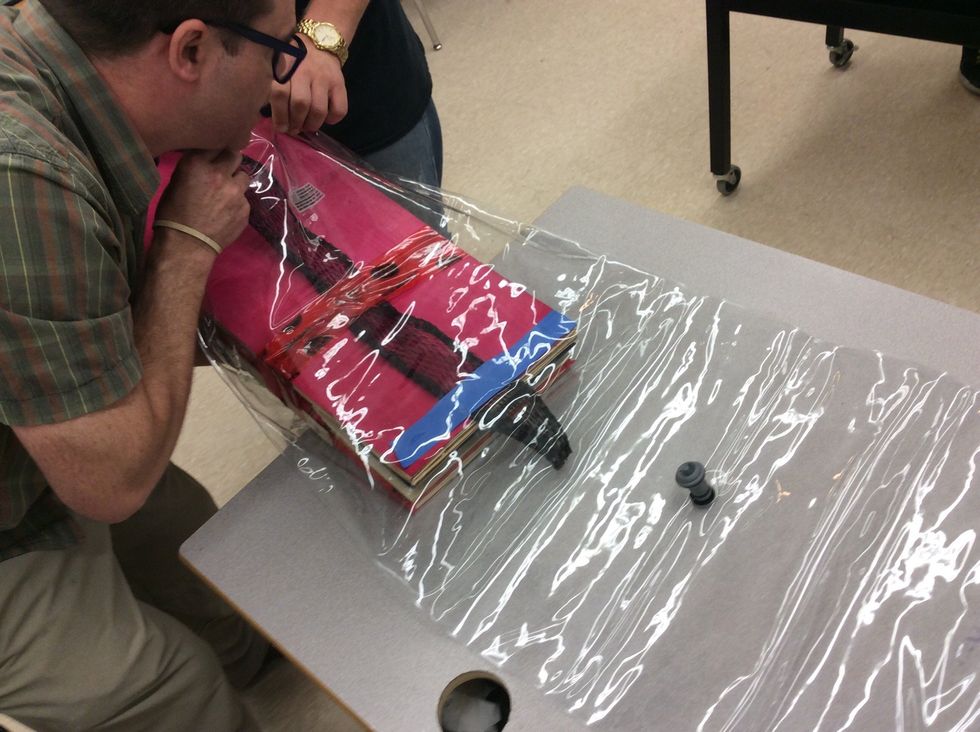 Now, gently place the board inside the large bag. Be careful putting it in try not to pinch the bag or damage the pump valve.