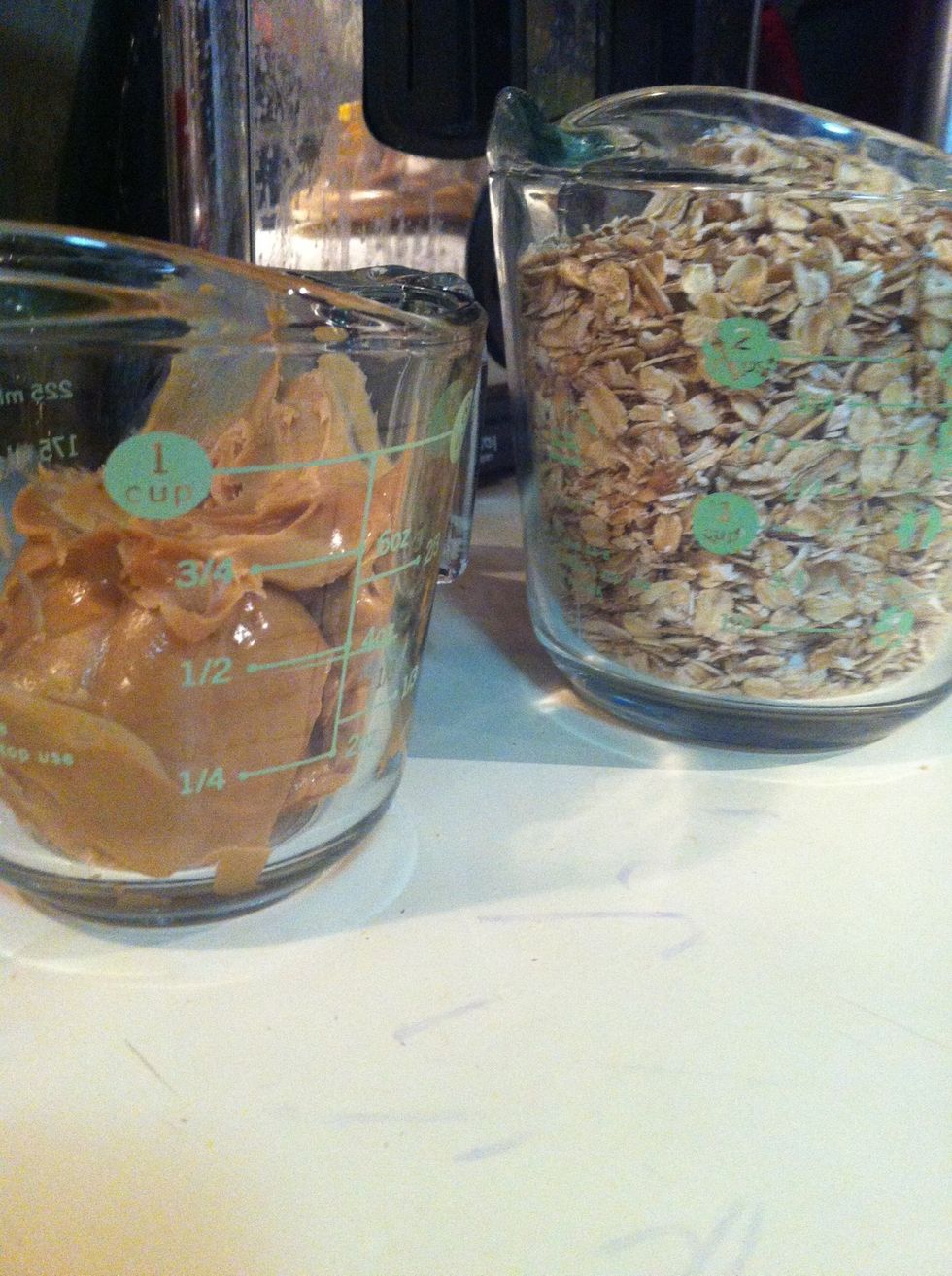 Now get 1/2 cup of peanut butter (heat up a metal spoon so it's easier to get out) and 2 1/2 cups of oats