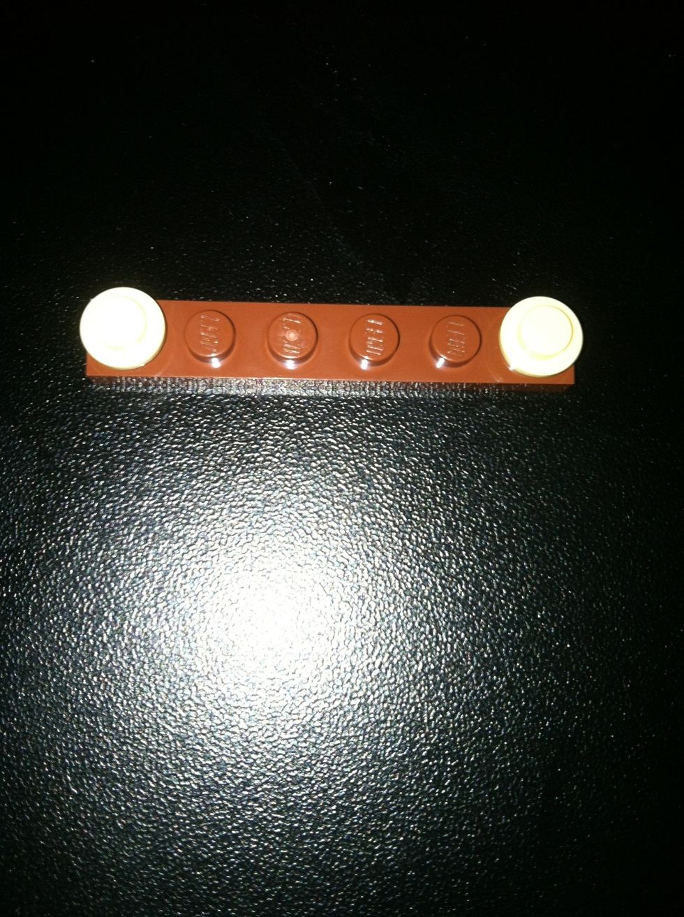 Now get a 6 holed brown piece a two small white pieces for ears