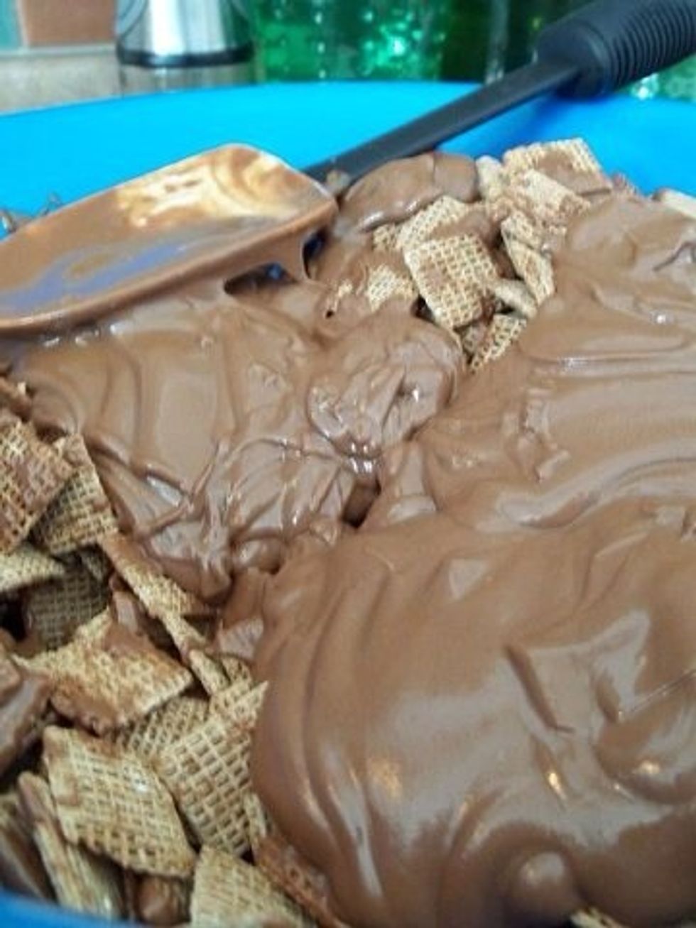 Now get a big bowl ready add your chex mix and pour chocolate mixture over. I add about half the bowl then stir and then add the remaining chocolate. I find it's easier to stir doing it that way.