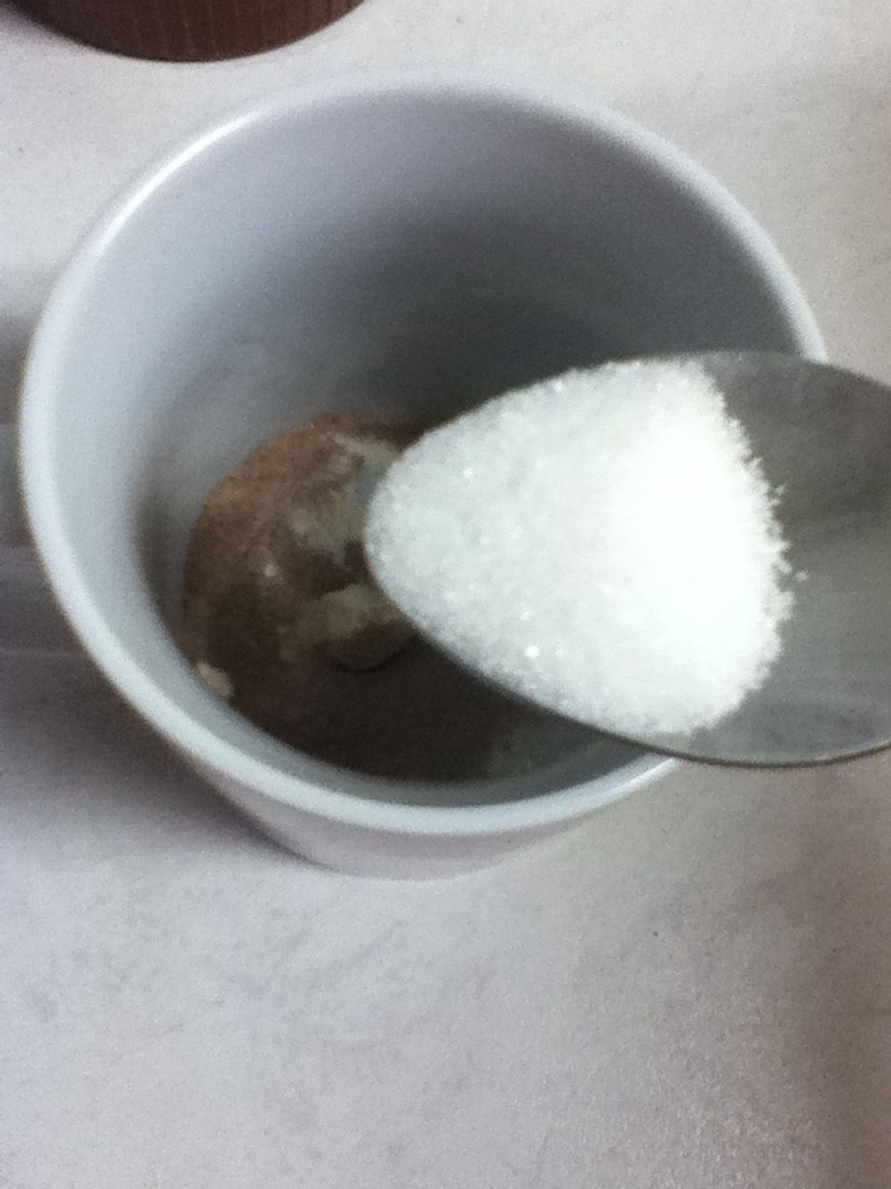 Now get a tablespoon or two full of sugar and put it right in there!