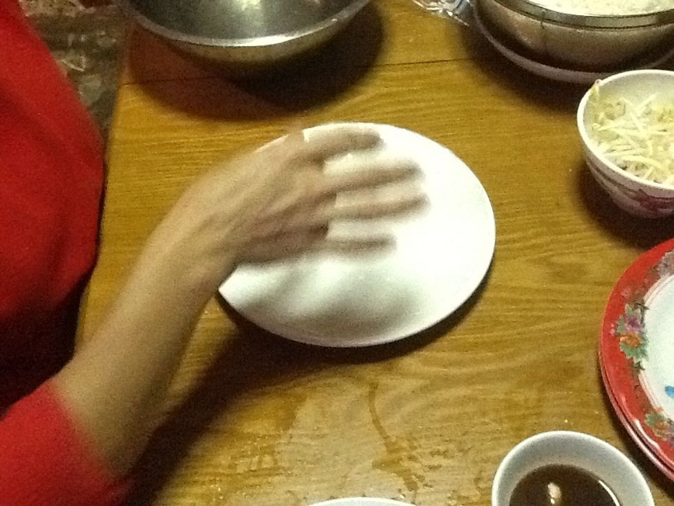 Now get the rice paper and put it into the warm water and place it on a dish and let it rest.