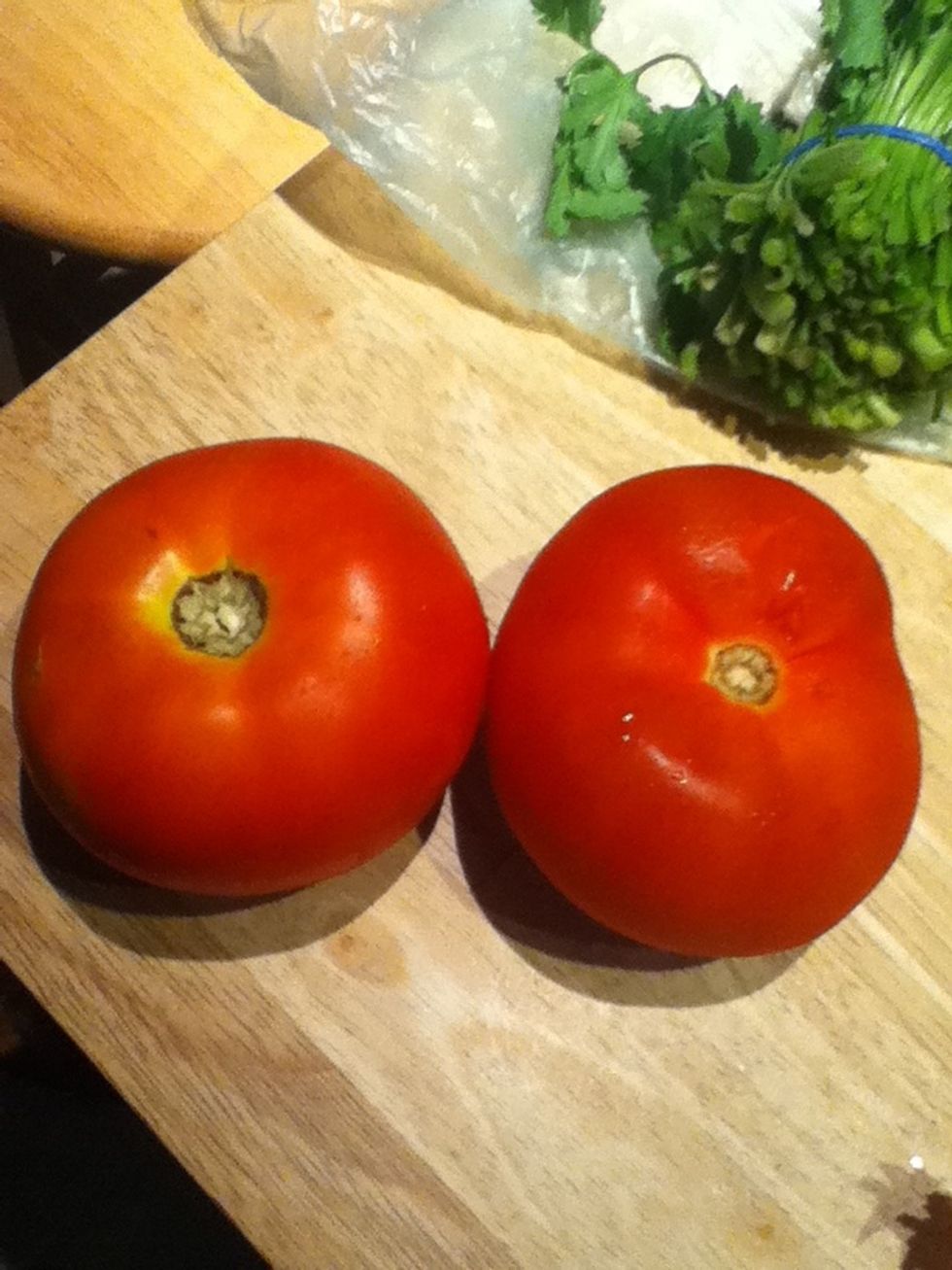 Now get your two tomatoes and cut them into small cubes, add them to the bowl