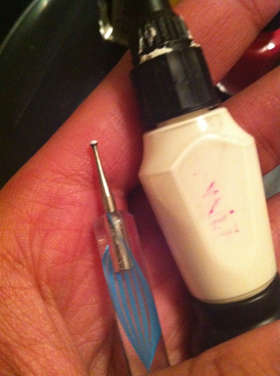 Now get your white varnish and your pin, you can also  use the nail art pens that have the pen on the end
