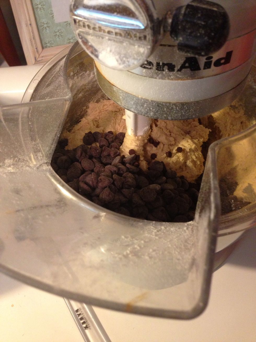 Now go ahead and pour in your chocolate chips. I do 50/50 mix of mini chips and regular chips. If you wanted to add nuts, now is the time. Mix on low for about 10-15 seconds and then stop.