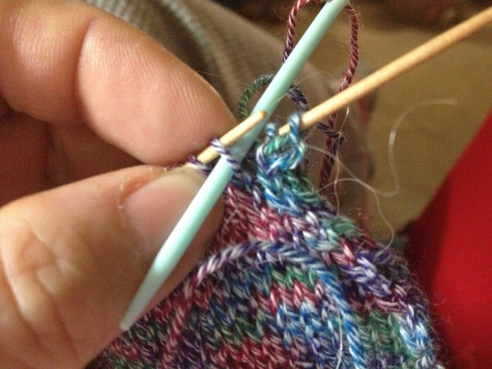 Now go purlwise through the next stitch on the front needle. (It was the 2nd stitch, now it's the 1st since you let the 1st stitch drop,)