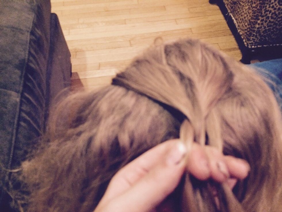 Now grab another strand from the side and add it to the strand that you would've crossed over next In a normal braid