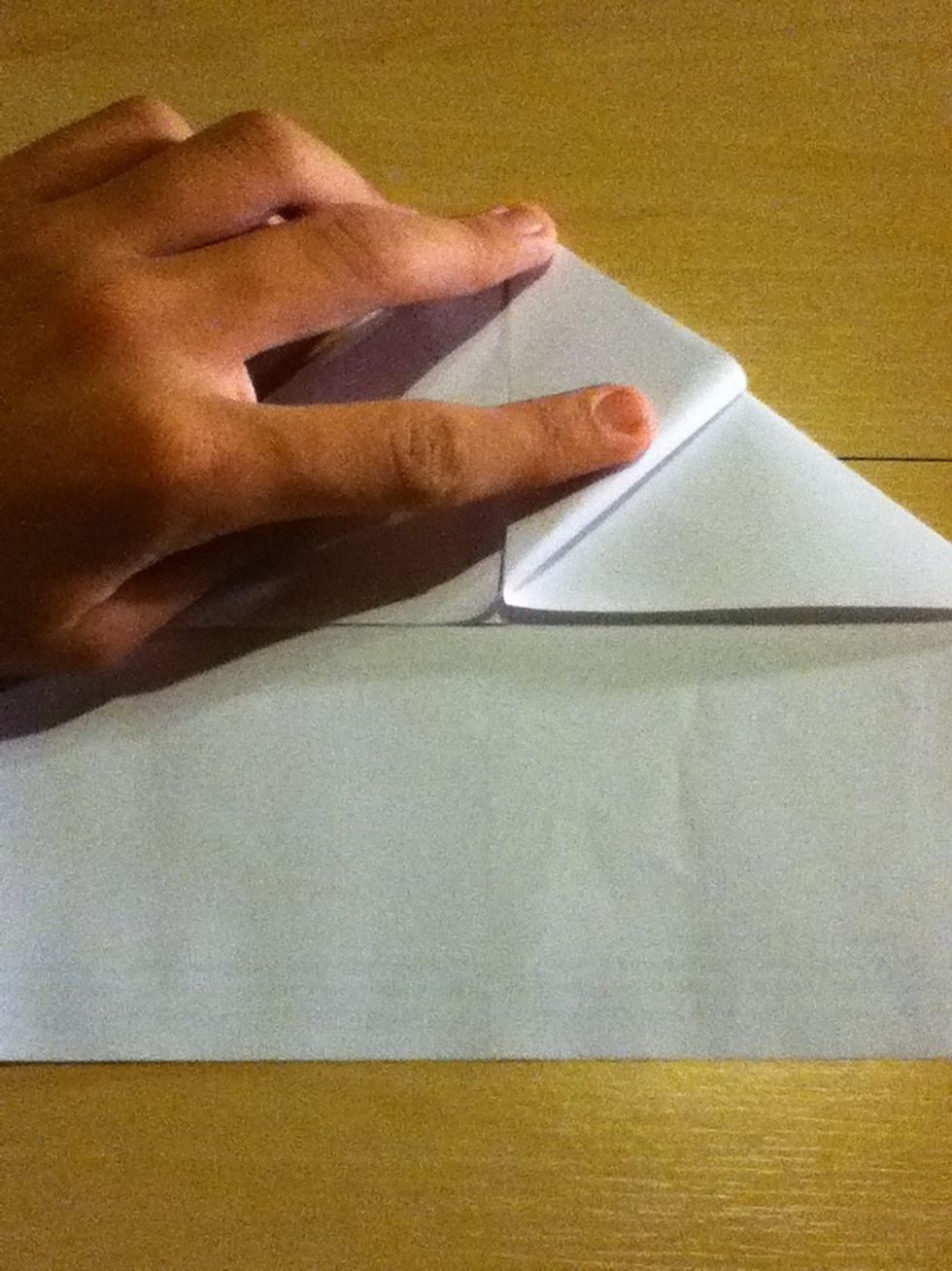 Now grab the bottom of the upper triangle and fold it like on the picture. Do this with both sides