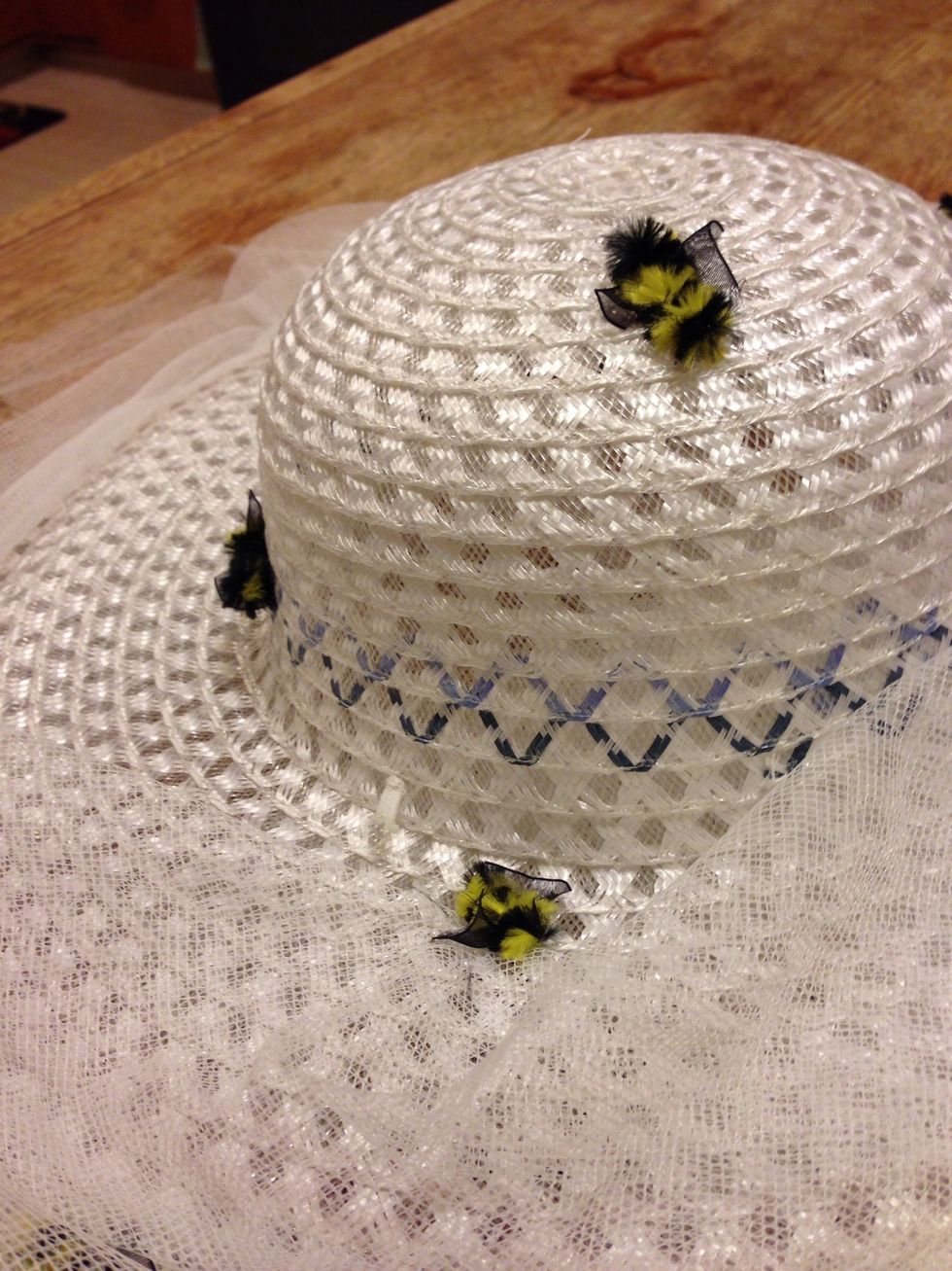 Now, grab your bees and sew or glue a few of them into the hat.