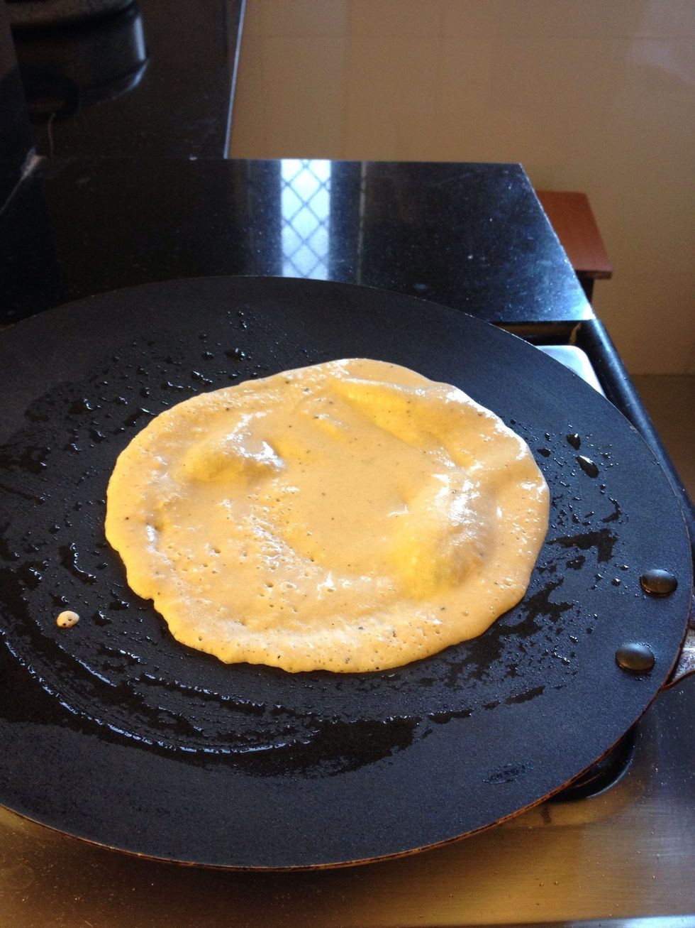 Now heat a non stick fry pan, add half a teaspoon of olive oil and add a dollop of the pancake mix. Spread evenly to give a round pancake shape. Let it cook.