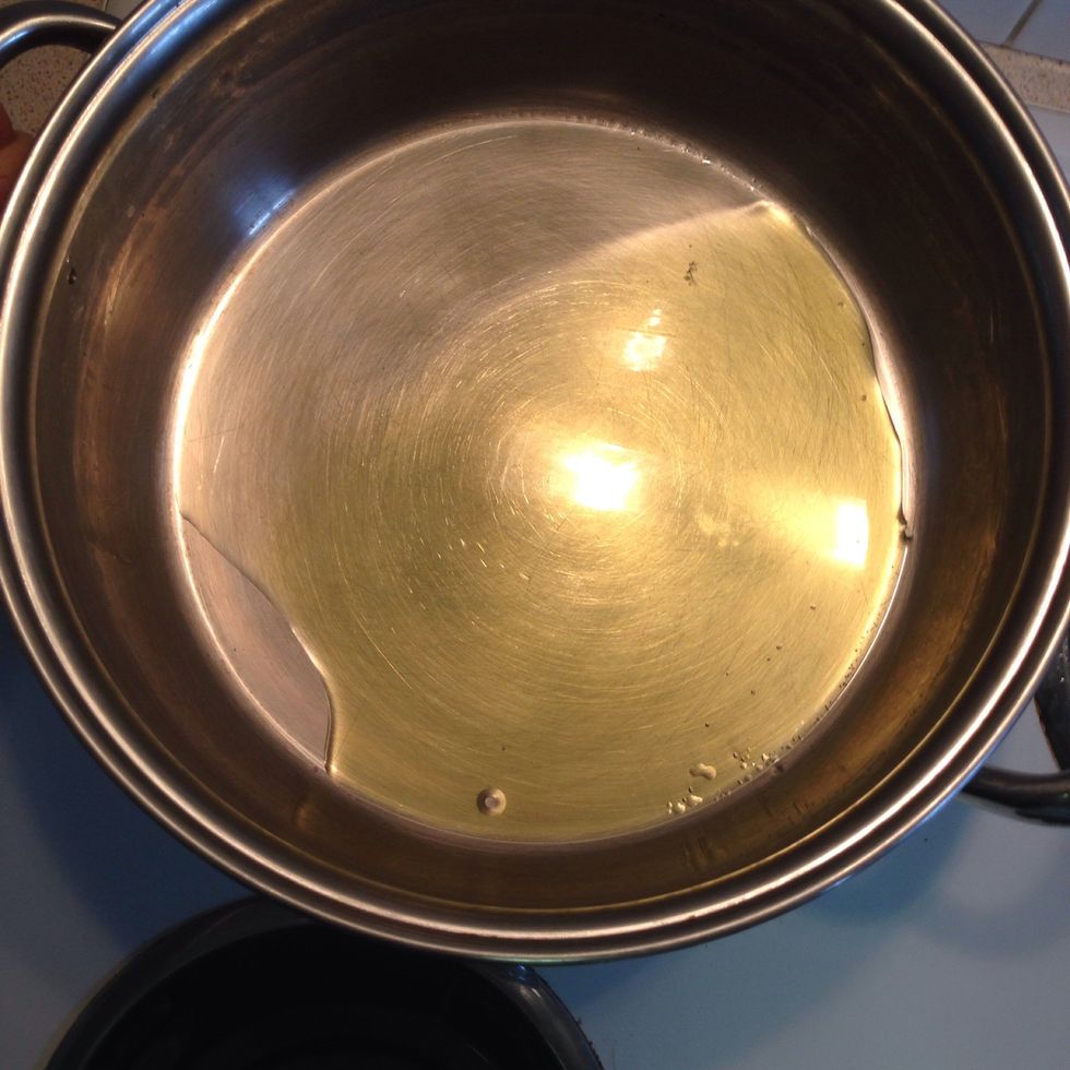Now, heat the large pot you intend to cook the cabbage in with 2-3 tbsp of extra virgin olive oil. Add pounded garlic and crushed coriander to the pot and saut\u00e9e for a minute then remove from heat.