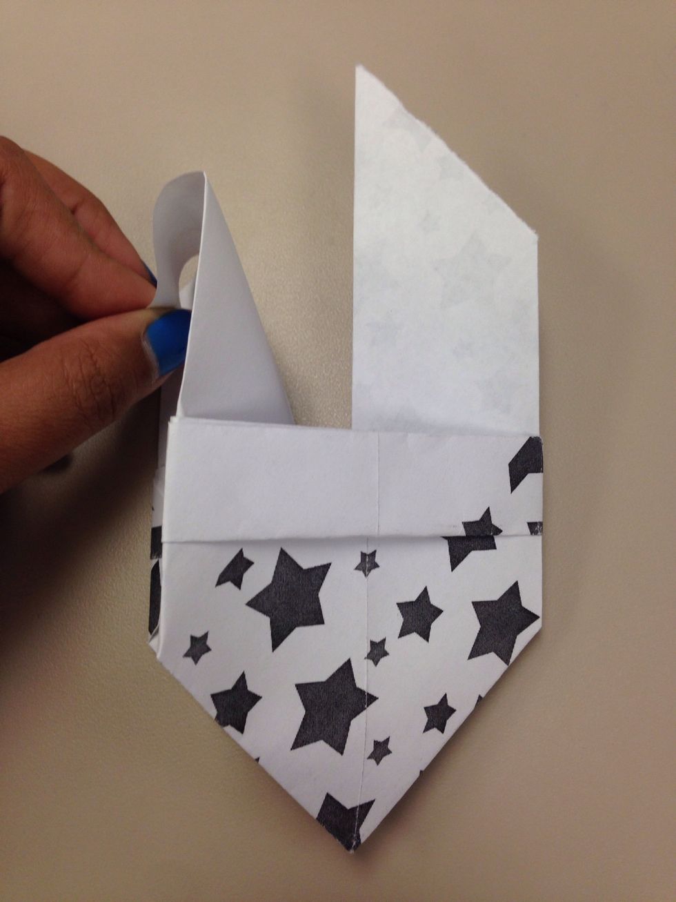 Now hold it as shown and pull it downwards. This should be easy because we have been creasing everything from the start.