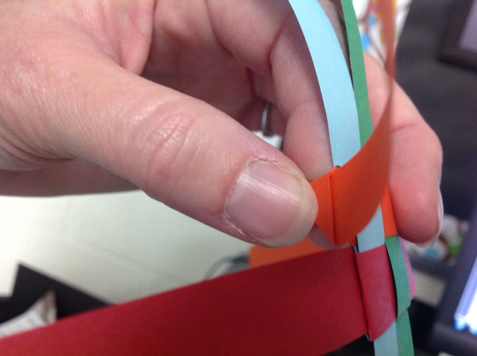 Now hold the tip of the folded triangle.