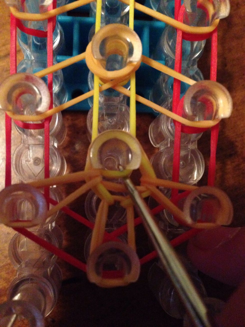 Now hook on to the yellow rubber band