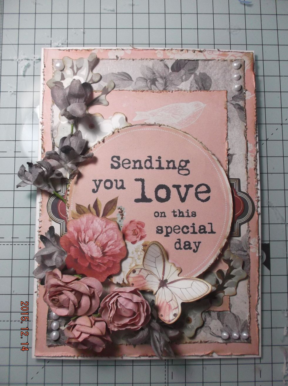 Now I added my flowers. The Petaloo flower spray I trimmed to fit and used the left over flowers else where on the card. I slightly bent and shaped my butterfly and stuck onto card.