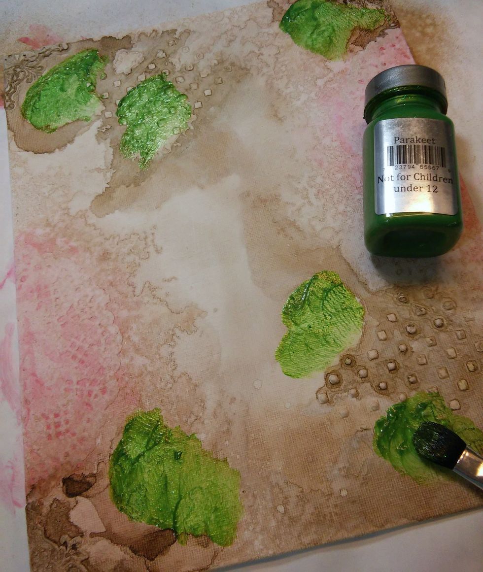 Now I chose Parakeet Sorbet Paint to add spots of green in a few of the lighter spots left on the canvas.