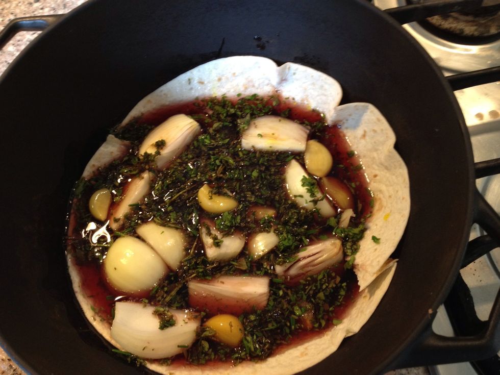 Now I didn't have carrots or parsnip, so I added a few more onions and a bread wrap in the bottom of my pot so soak up moisture. Add all veggies half the chopped spices and all the red wine