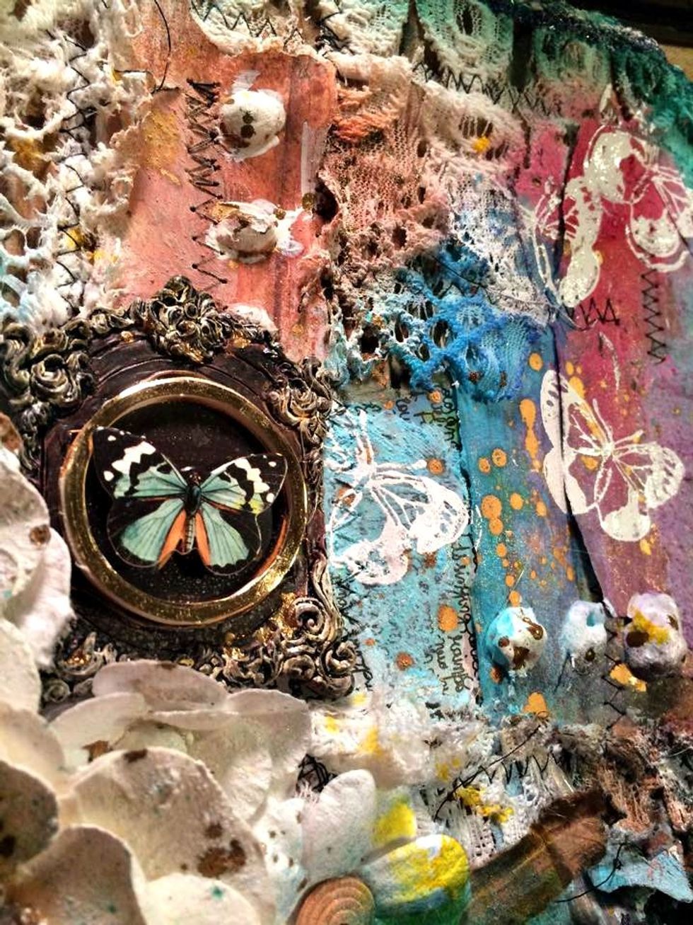 Now I glued down my ornate frame and glued a dimensional butterfly sticker on top of that. I also glued down the little license plate that says Remember 2 Live Your Dream